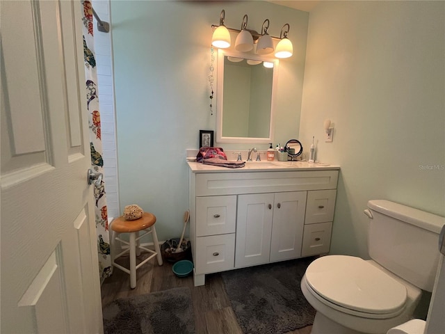 bathroom featuring vanity, toilet, and hardwood / wood-style floors