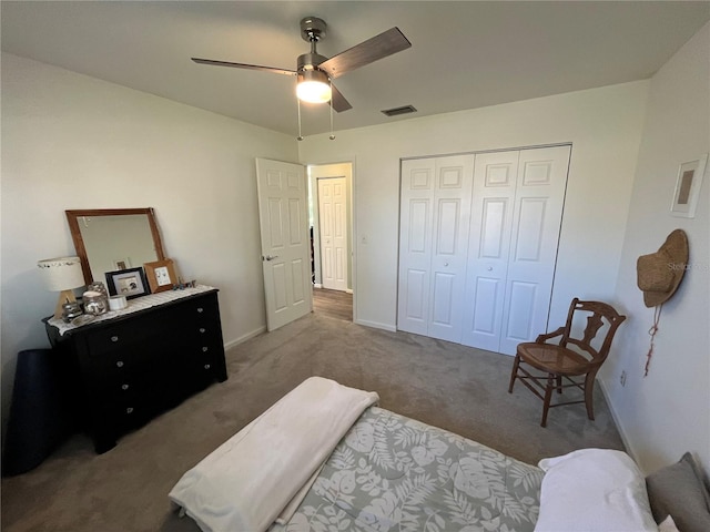 bedroom with a closet, ceiling fan, and dark colored carpet