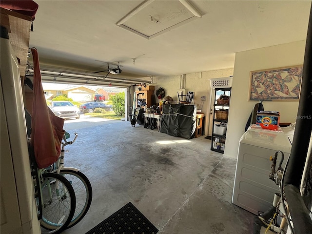 garage featuring a garage door opener and separate washer and dryer