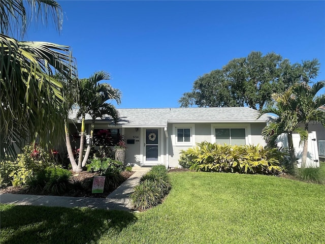 5730 16th Ln NE, Saint Petersburg, FL 33703 - ranch-style home featuring stucco siding and a front lawn