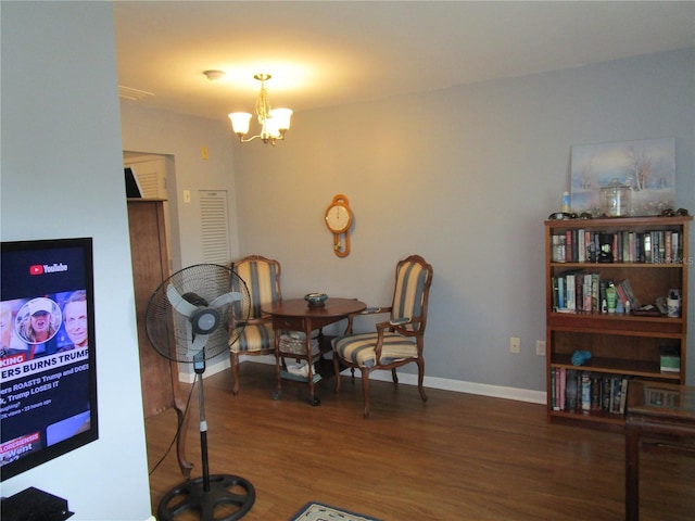 dining area with dark hardwood / wood-style flooring and a chandelier