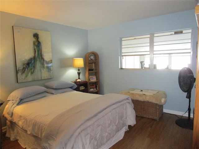 bedroom with dark wood-type flooring