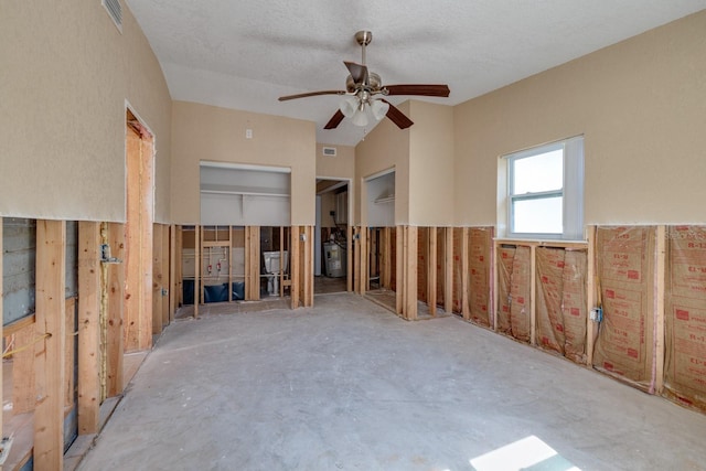 empty room with ceiling fan and concrete floors