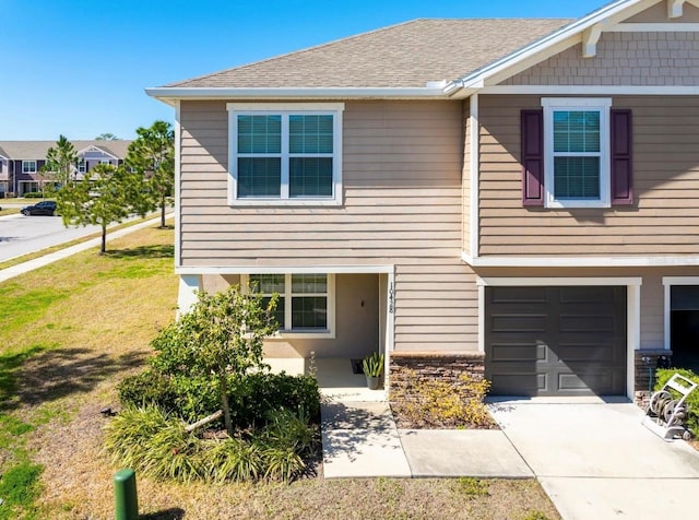 view of front of house with a garage and a front yard