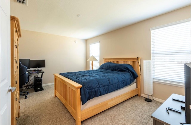 bedroom featuring light carpet