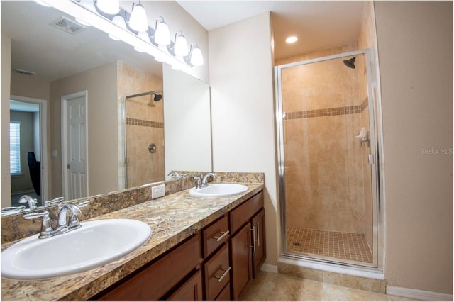 bathroom featuring vanity, an enclosed shower, and tile patterned floors