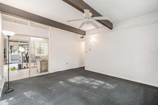 spare room with ceiling fan, carpet floors, and beamed ceiling