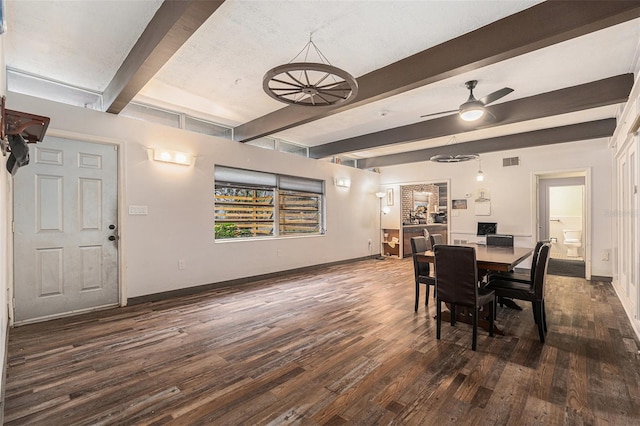 dining area featuring ceiling fan, dark hardwood / wood-style flooring, and beam ceiling