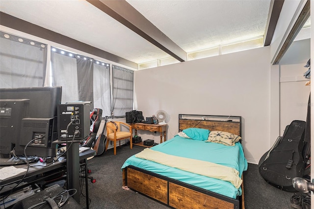 bedroom featuring beam ceiling and a textured ceiling