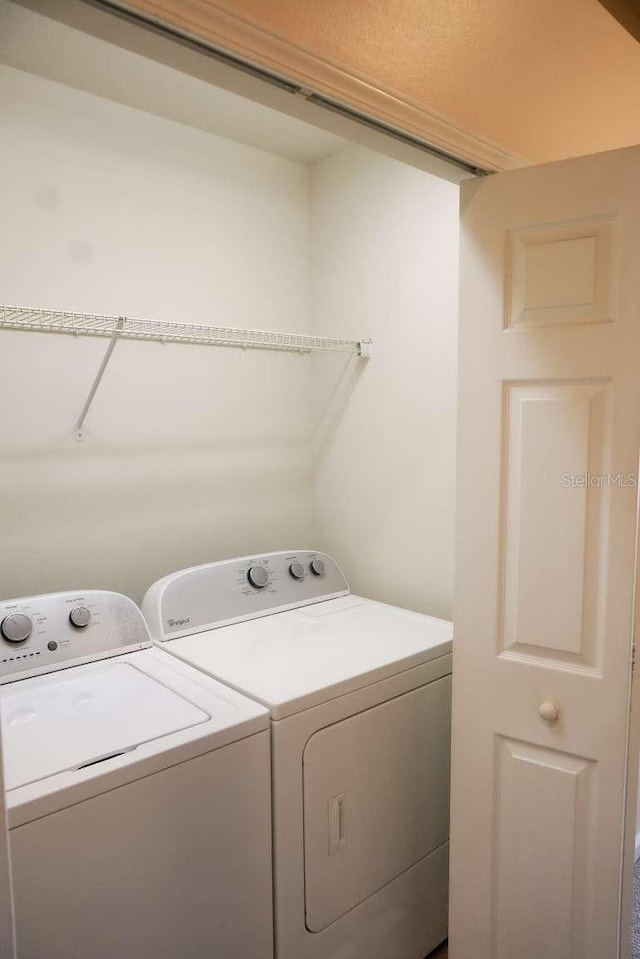 laundry area featuring separate washer and dryer and laundry area