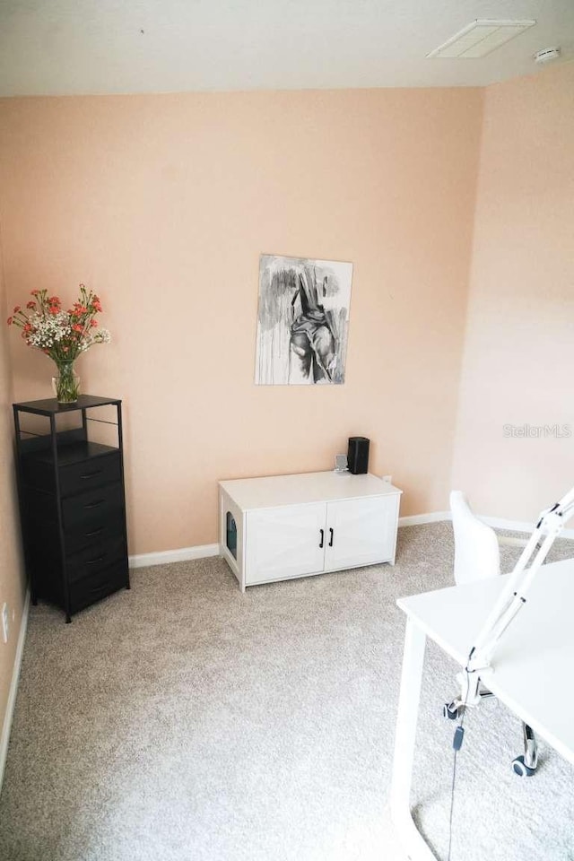 sitting room featuring baseboards, light carpet, and visible vents