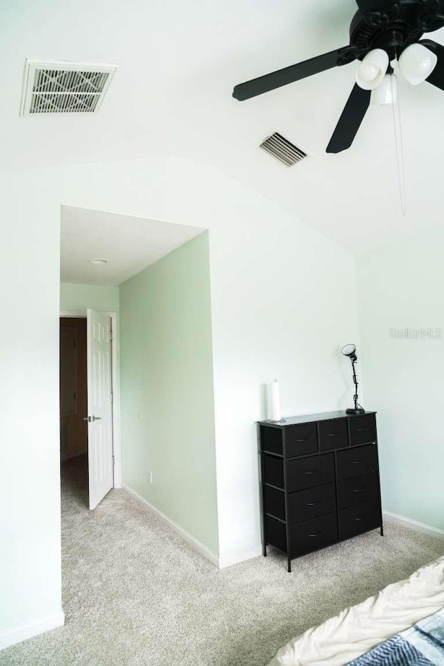 bedroom with light carpet, visible vents, and a ceiling fan