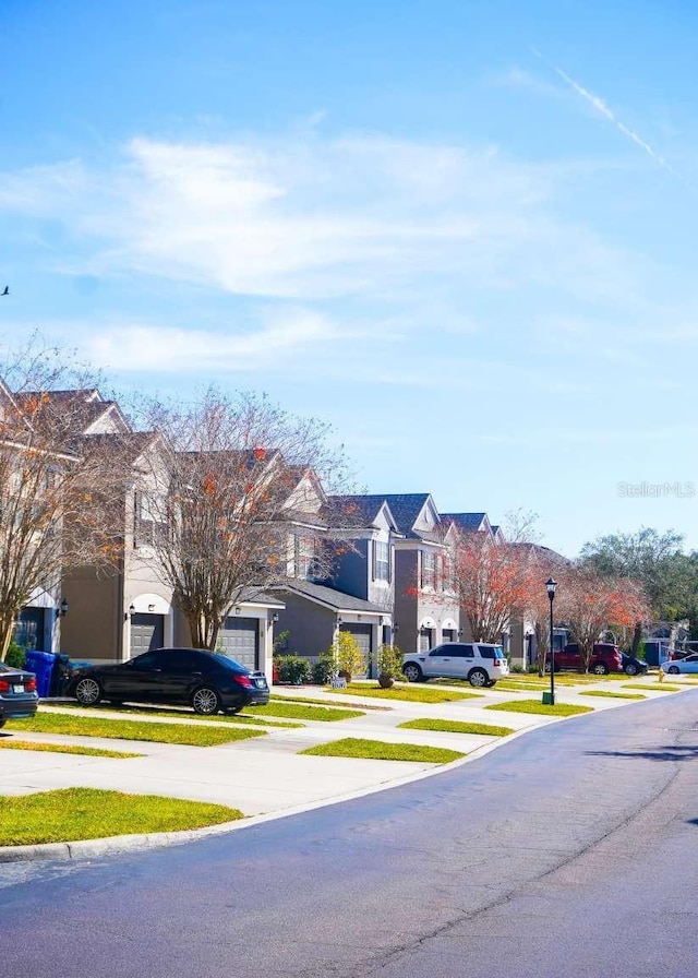 view of street with a residential view and street lights