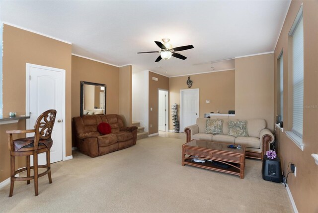 living room with light carpet, crown molding, and stairway