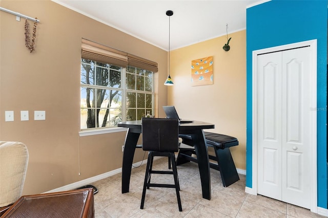 office space featuring baseboards, crown molding, and light tile patterned flooring