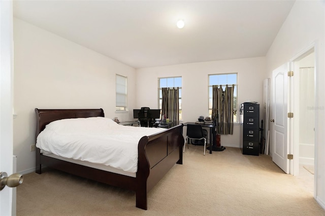 bedroom featuring light colored carpet and baseboards