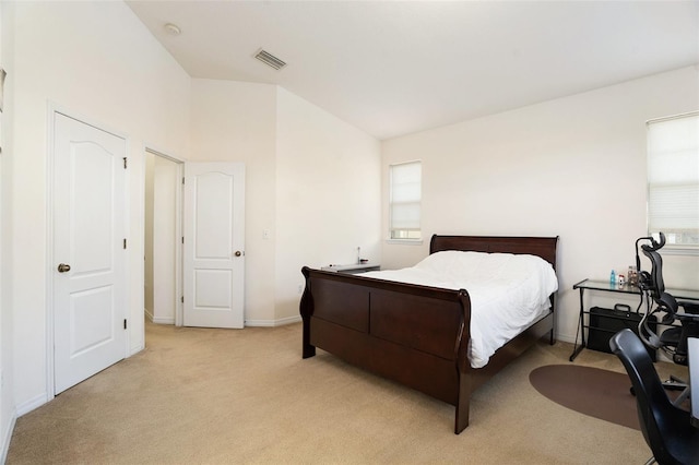 bedroom with light carpet, multiple windows, visible vents, and lofted ceiling