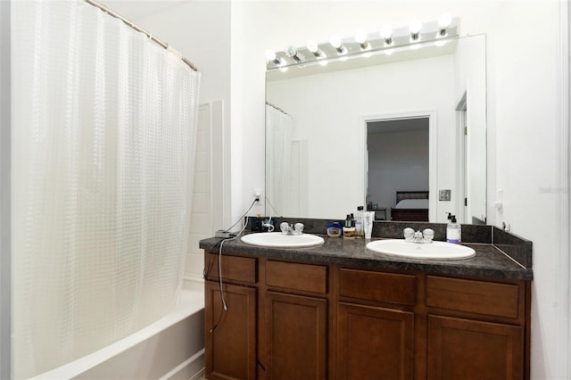 ensuite bathroom featuring double vanity, shower / bath combo, connected bathroom, and a sink