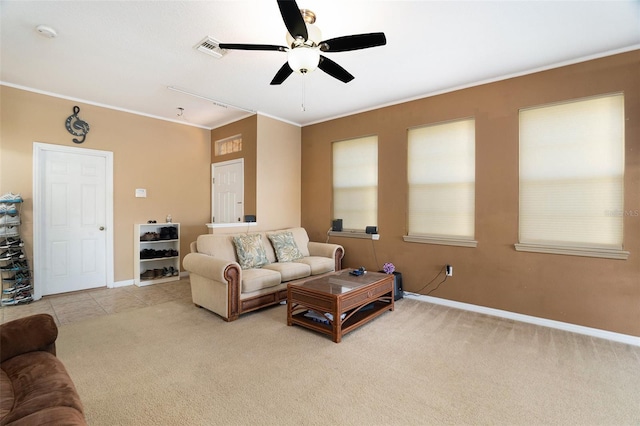 living room featuring light tile patterned floors, baseboards, visible vents, light colored carpet, and crown molding