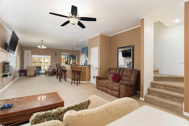 living room featuring light carpet, baseboards, and stairway