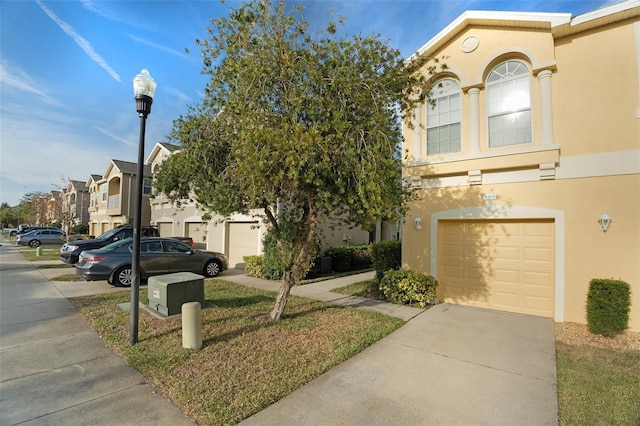 9111 Moonlit Meadows Loop, Riverview, FL 33578 - view of front of property with stucco siding, driveway, and a garage