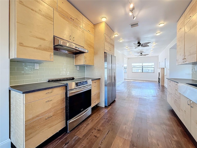 kitchen featuring ceiling fan, stainless steel appliances, dark hardwood / wood-style floors, tasteful backsplash, and light brown cabinetry