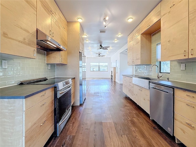 kitchen featuring sink, dark wood-type flooring, ceiling fan, appliances with stainless steel finishes, and light brown cabinets