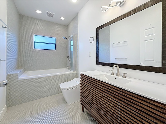 full bathroom featuring vanity, tiled shower / bath combo, tile patterned floors, and toilet