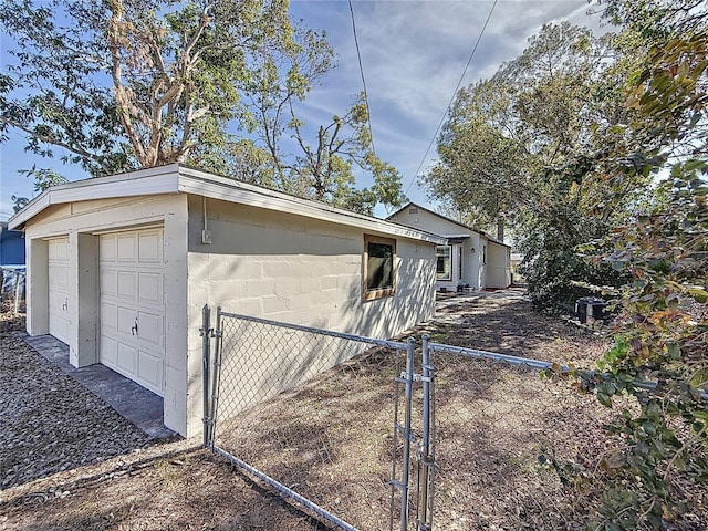 view of side of home with an outbuilding and a garage