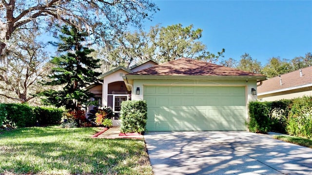 view of front of home with a garage and a front lawn