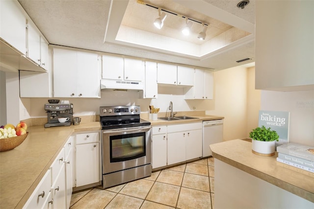 kitchen with sink, stainless steel electric range, white dishwasher, a raised ceiling, and white cabinets