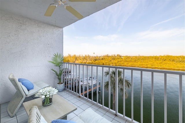 balcony featuring ceiling fan and a water view