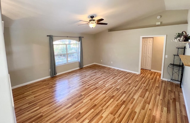 unfurnished living room with vaulted ceiling, light hardwood / wood-style floors, and ceiling fan