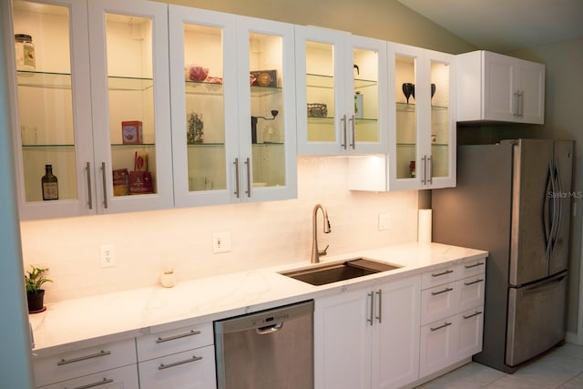 kitchen with light stone countertops, white cabinets, and appliances with stainless steel finishes