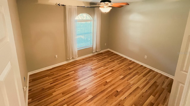 empty room with light hardwood / wood-style floors and ceiling fan