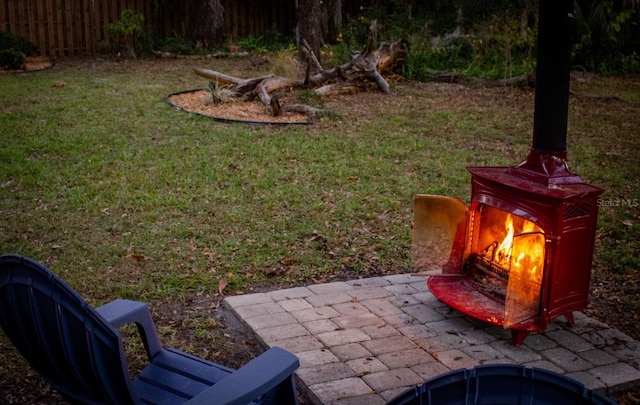 view of yard with an outdoor fireplace and a patio