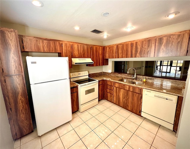 kitchen featuring white appliances, sink, and light tile patterned floors