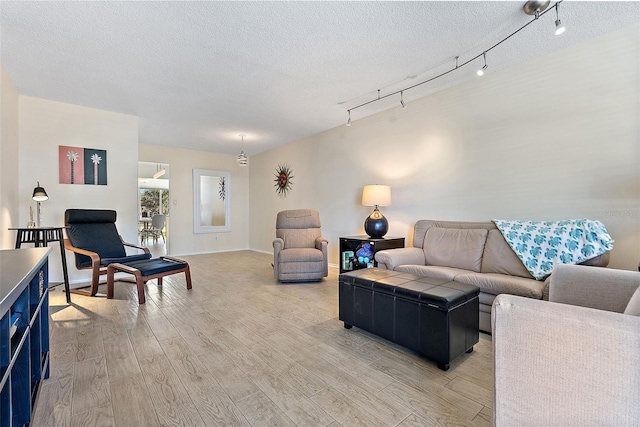 living room featuring light hardwood / wood-style flooring and a textured ceiling