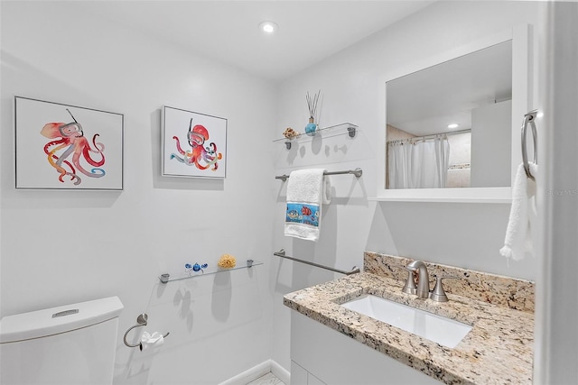 bathroom featuring vanity, toilet, and a shower with shower curtain