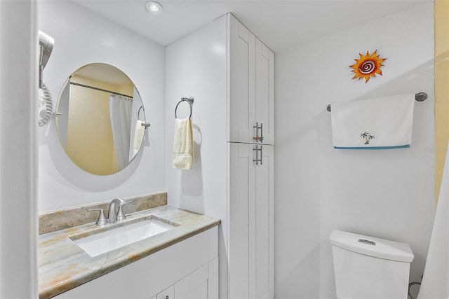 bathroom featuring vanity, a shower with shower curtain, and toilet