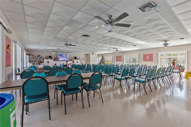 dining area featuring a drop ceiling