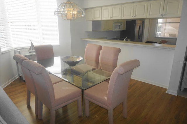 dining area featuring a notable chandelier and hardwood / wood-style flooring