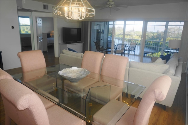 dining area featuring hardwood / wood-style floors and ceiling fan with notable chandelier