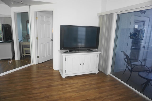 unfurnished living room with dark wood-type flooring