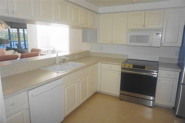 kitchen with sink, white appliances, and light tile patterned floors