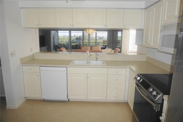 kitchen with white cabinetry, white appliances, sink, and light tile patterned floors