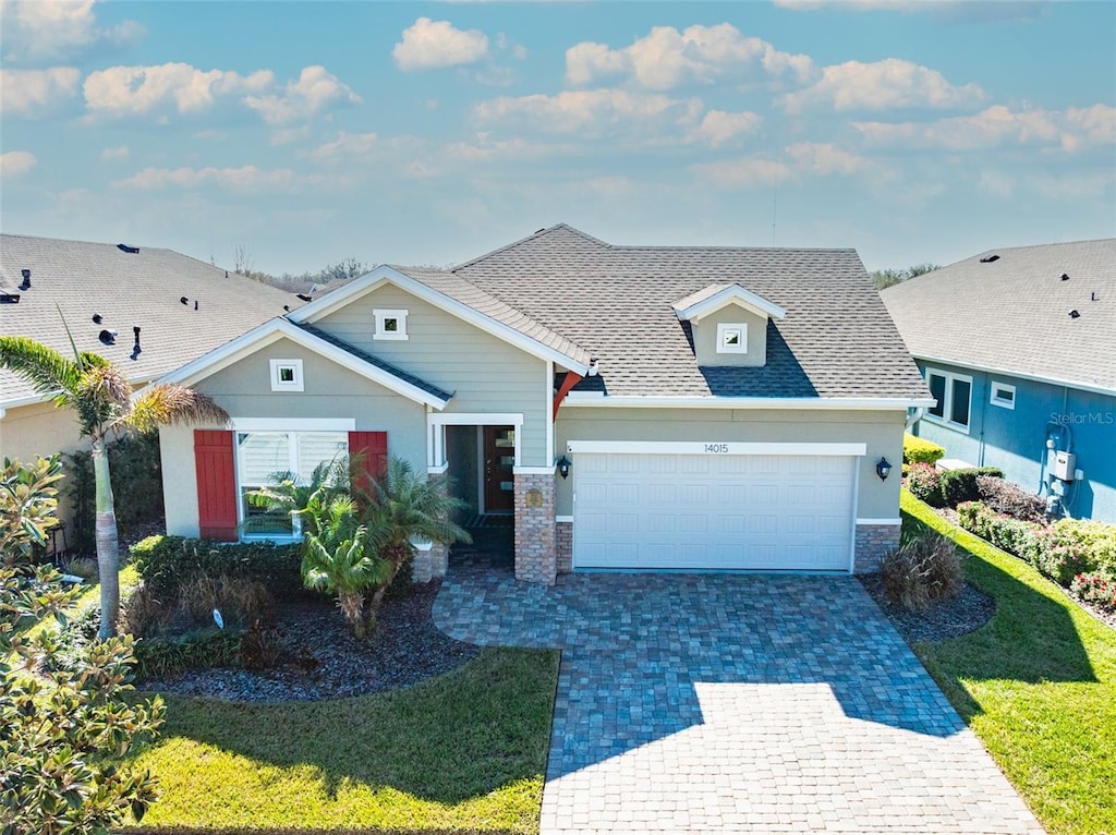 view of front of property with a garage and a front lawn