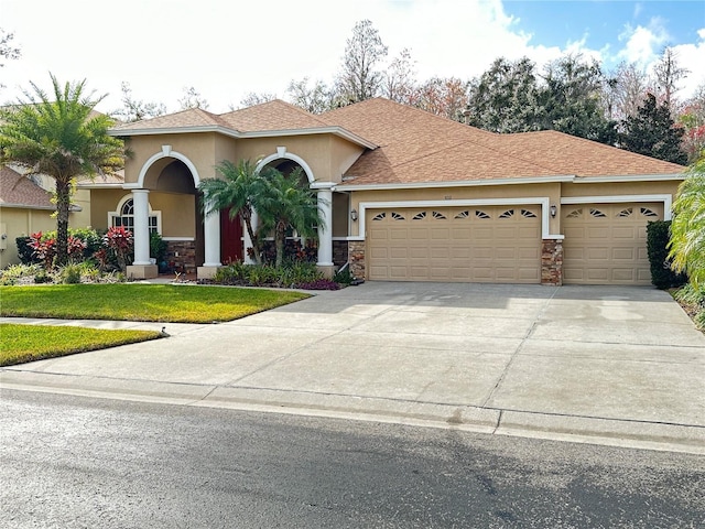 view of front facade featuring a garage and a front lawn