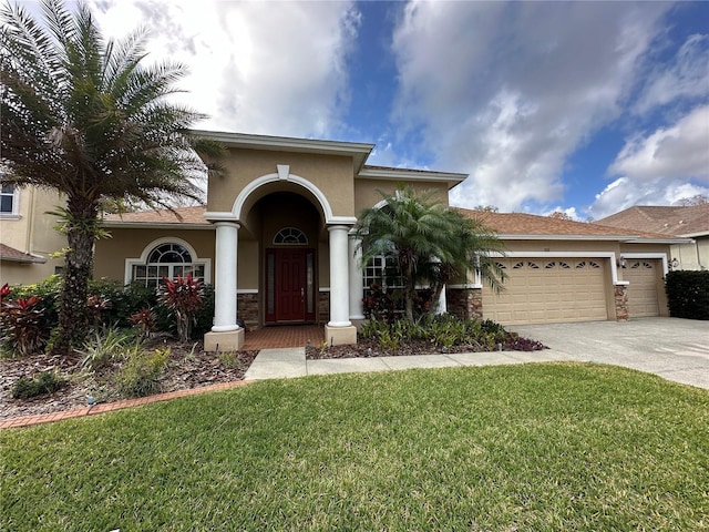 view of front of property featuring a garage and a front yard