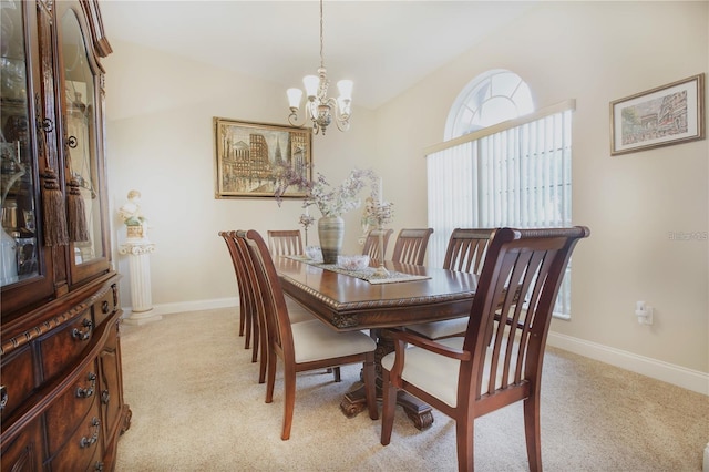 dining room with a notable chandelier and light colored carpet